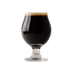 Glass of dark beer with a white background