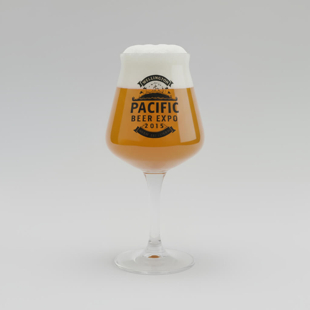 Glass of beer with 'Pacific Beer Expo 2015' label on a gray background