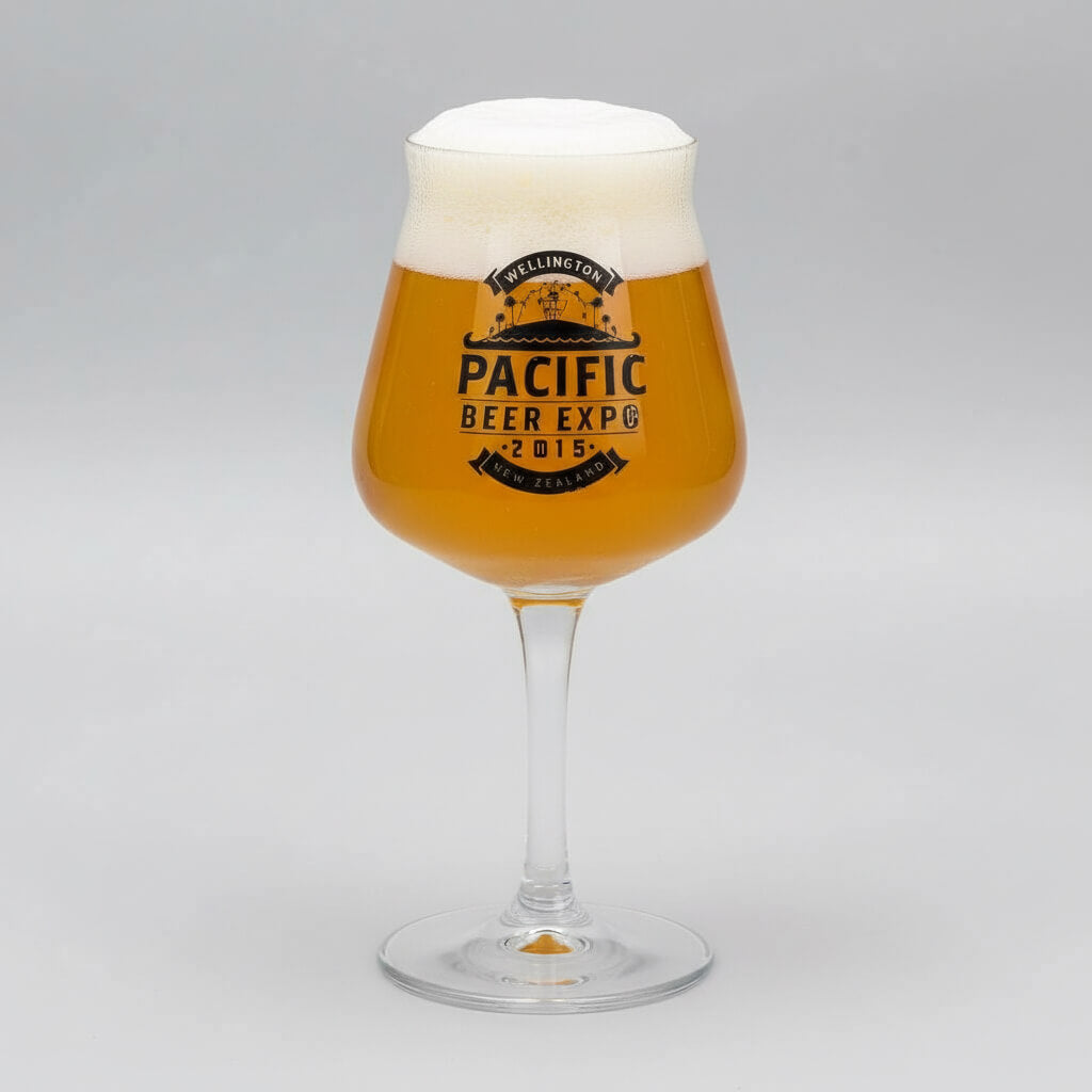 Glass of beer with Pacific Beer Expo 2015 branding on a gray background