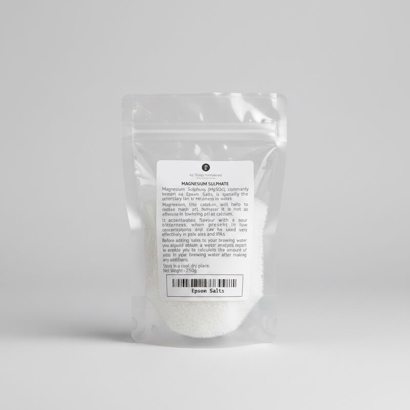 A clear plastic stand-up pouch containing white Epsom salt, with a white label showing the text 'MAGNESIUM SULPHATE' and 'Epsom Salts', photographed on a neutral light gray background.