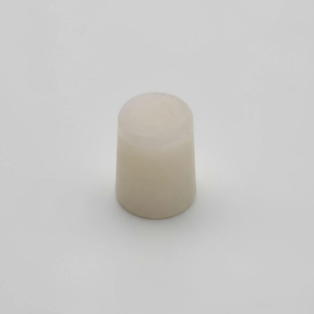 Beige cylindrical object on a white background