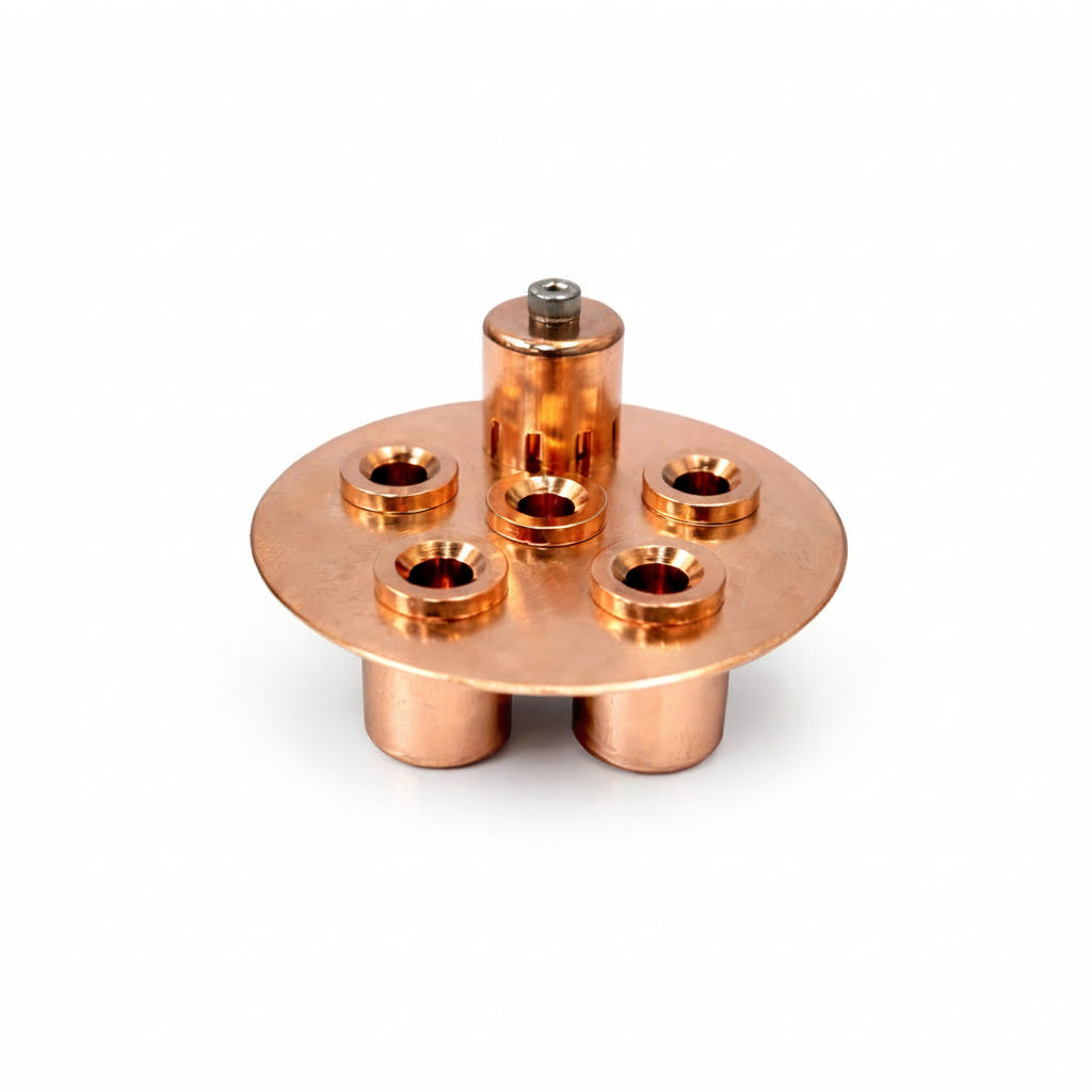 Copper metal bubble plate with multiple holes on a white background